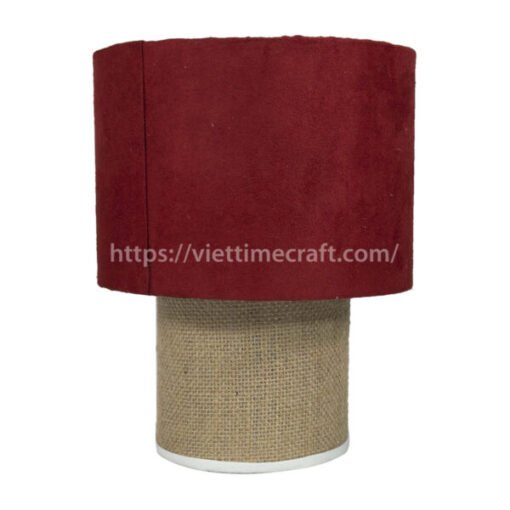 A table lamp with a red fabric shade and a jute-covered base